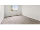 Bright bedroom with large window and plush neutral carpeting at 1261 E 135Th Pl, Thornton, CO 80241