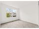 Bright bedroom with large window and plush neutral carpeting at 1261 E 135Th Pl, Thornton, CO 80241