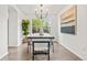 Elegant dining room features a modern chandelier, large window, and contemporary artwork at 1261 E 135Th Pl, Thornton, CO 80241