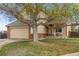 Charming two-story home features a brick facade, two-car garage, and inviting front porch at 1261 E 135Th Pl, Thornton, CO 80241
