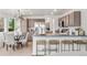 Modern kitchen with a breakfast bar, stainless steel appliances, and stylish pendant lighting at 1261 E 135Th Pl, Thornton, CO 80241