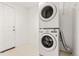 Functional laundry room featuring a stacked washer and dryer unit at 1261 E 135Th Pl, Thornton, CO 80241