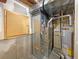 Unfinished basement area with HVAC and water heater at 445 Tumbleweed Dr, Brighton, CO 80601