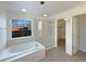 Bathroom with soaking tub, shower, and walk-in closet at 445 Tumbleweed Dr, Brighton, CO 80601