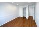 Bedroom with hardwood floors and access to hallway at 445 Tumbleweed Dr, Brighton, CO 80601