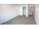 Well-lit bedroom with grey carpet and access to hallway at 445 Tumbleweed Dr, Brighton, CO 80601