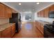 Kitchen with wood cabinets, granite countertops, and hardwood floors at 445 Tumbleweed Dr, Brighton, CO 80601