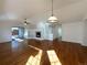 Spacious living room featuring hardwood floors, a fireplace, and lots of natural light at 445 Tumbleweed Dr, Brighton, CO 80601