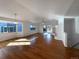 Bright living room with hardwood floors, fireplace, and sliding glass doors to backyard at 445 Tumbleweed Dr, Brighton, CO 80601