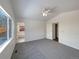 Main bedroom with carpet, ceiling fan and access to bathroom at 445 Tumbleweed Dr, Brighton, CO 80601