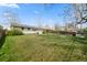 Large backyard with a fenced-in area and green grass at 8012 Zuni St, Denver, CO 80221