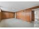 Basement with paneled walls, tile floors, and a doorway to another room at 8012 Zuni St, Denver, CO 80221