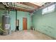 Unfinished basement with a water heater and exposed utilities at 8012 Zuni St, Denver, CO 80221