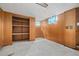 Unfinished basement space with built-in shelving and small windows at 8012 Zuni St, Denver, CO 80221