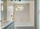 Bathroom featuring a shower and tub combo with tiled walls at 8012 Zuni St, Denver, CO 80221
