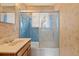 Cozy bathroom with shower and tub combination, vanity, and patterned wallpaper at 8012 Zuni St, Denver, CO 80221