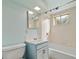 Bathroom with a bathtub, shower, and blue vanity at 8012 Zuni St, Denver, CO 80221