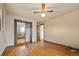 Spacious bedroom featuring hardwood floors, ceiling fan, and closet with sliding mirrored doors at 8012 Zuni St, Denver, CO 80221