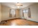 Bright bedroom with hardwood floors, two windows letting in natural light, and a ceiling fan at 8012 Zuni St, Denver, CO 80221
