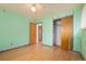 Bedroom featuring hardwood floors, closet, and an open doorway at 8012 Zuni St, Denver, CO 80221