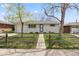 Charming ranch-style home with a well-maintained front yard and traditional white brick at 8012 Zuni St, Denver, CO 80221