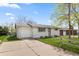 Charming exterior view of home featuring a well-manicured lawn and concrete driveway at 8012 Zuni St, Denver, CO 80221