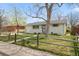 Charming exterior view of home featuring a well-manicured lawn and quaint wooden fence at 8012 Zuni St, Denver, CO 80221