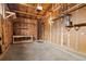 Unfinished garage showcasing an open ceiling, exposed studs, and a concrete floor at 8012 Zuni St, Denver, CO 80221