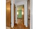 Hallway showing multiple doors leading to rooms with hardwood floors and wood-trimmed doors at 8012 Zuni St, Denver, CO 80221