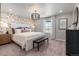 Spacious bedroom featuring a decorative accent wall, large windows, and stylish furnishings at 2086 Wagon Wheel Aly, Brighton, CO 80601