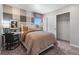 Cozy bedroom featuring a patterned accent wall, window, and closet with sliding doors at 2086 Wagon Wheel Aly, Brighton, CO 80601