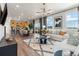 Open-concept living room with kitchen, dining, and stylish decor at 2086 Wagon Wheel Aly, Brighton, CO 80601