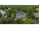 Aerial view of the back of a lovely green home, with mature trees and lawn in a peaceful neighborhood at 2240 Summitview Dr, Longmont, CO 80504