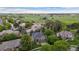 Aerial view of a neighborhood with green lawns, mature trees, and a home backing to a farm at 2240 Summitview Dr, Longmont, CO 80504