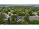 An overhead view shows mature trees and green lawns of a home in a quiet neighborhood with mountains beyond at 2240 Summitview Dr, Longmont, CO 80504