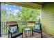 Relax on this outdoor balcony, complete with seating and green treetop views at 2240 Summitview Dr, Longmont, CO 80504