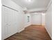 Finished basement space with wood-look tile flooring and closet storage at 2240 Summitview Dr, Longmont, CO 80504