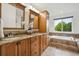 A bathroom boasts dual sinks, granite countertops, and a relaxing soaking tub at 2240 Summitview Dr, Longmont, CO 80504