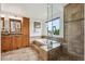 Bathroom featuring a soaking tub with tiled surround and a walk-in shower at 2240 Summitview Dr, Longmont, CO 80504