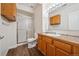 Well-lit bathroom featuring a tiled shower, wood-look flooring, and vanity with wood cabinets at 2240 Summitview Dr, Longmont, CO 80504