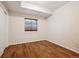 Cozy bedroom with wood-look floors, neutral walls, and a window dressed with wooden blinds at 2240 Summitview Dr, Longmont, CO 80504