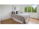 Bright bedroom features a large window, a light color scheme, and hardwood floors at 2240 Summitview Dr, Longmont, CO 80504