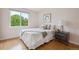 Bedroom featuring a bright window with green tree views, a bedside table, and a queen bed at 2240 Summitview Dr, Longmont, CO 80504
