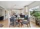 Bright dining area with hardwood floors, a glass table, and views into the adjacent kitchen with white cabinetry at 2240 Summitview Dr, Longmont, CO 80504