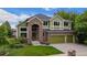 Charming two-story home with brick accents, manicured lawn, and a three-car garage at 2240 Summitview Dr, Longmont, CO 80504