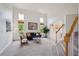 Bright living room boasts high ceilings, large windows, plush carpet, and stylish furnishings at 2240 Summitview Dr, Longmont, CO 80504