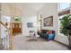 Bright living room boasts high ceilings, large windows, plush carpet, and stylish furnishings at 2240 Summitview Dr, Longmont, CO 80504