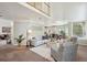Open-concept living area featuring a fireplace, neutral decor, and a view into the kitchen at 2240 Summitview Dr, Longmont, CO 80504