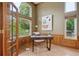 Office with a wall of windows, wooden trim, and a modern desk at 2240 Summitview Dr, Longmont, CO 80504