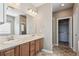 Bathroom featuring double sinks, large mirror, and a separate walk-in closet and shower at 11200 E 166Th Ave, Brighton, CO 80602